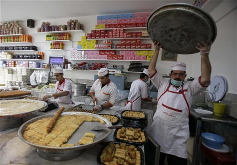 An Iraqi baker prepares sweets in Baghdad, Friday, July 29, in preparation for the Muslim fasting month of Ramadan, which is set to begin on August 1.